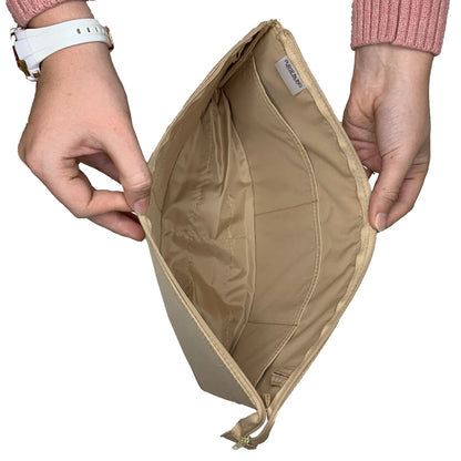 A person displays the spacious interior and durable zipper of the Purse Bling Slim Purse Organizer Insert with Zipper - Jumbo, highlighting its ideal use as a purse organizer.